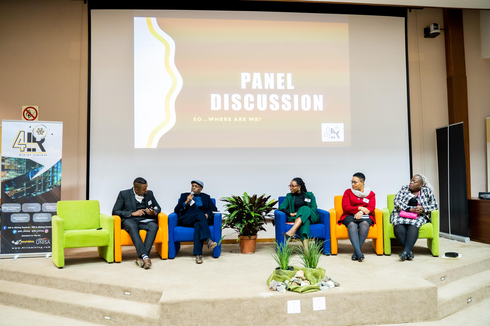 Panellists seated on stage during a panel discussion