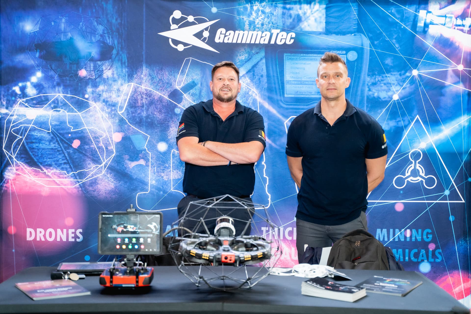 Exhibitors with an inspection drone on a technology stand