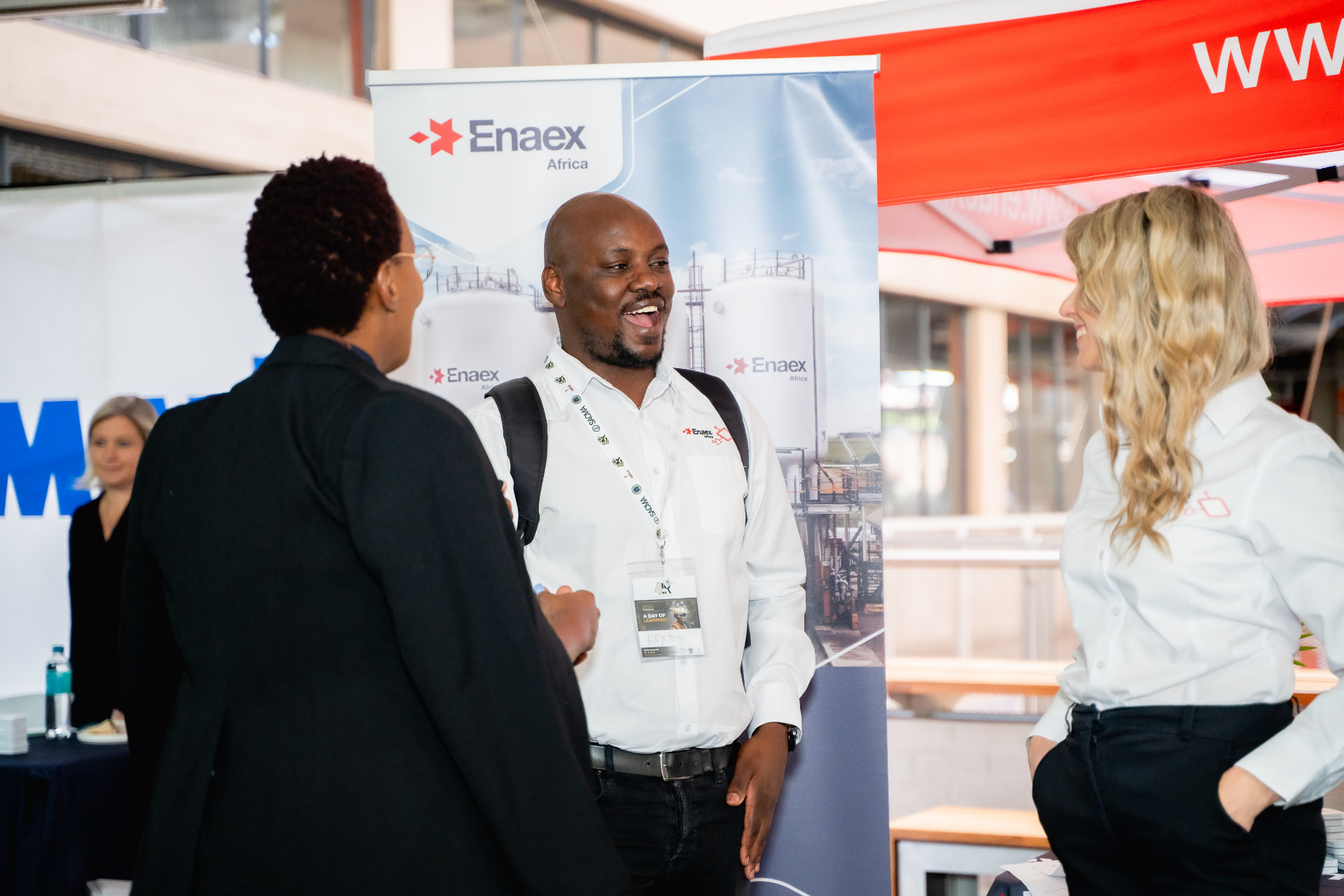 Exhibitor talking with delegates at a branded stand