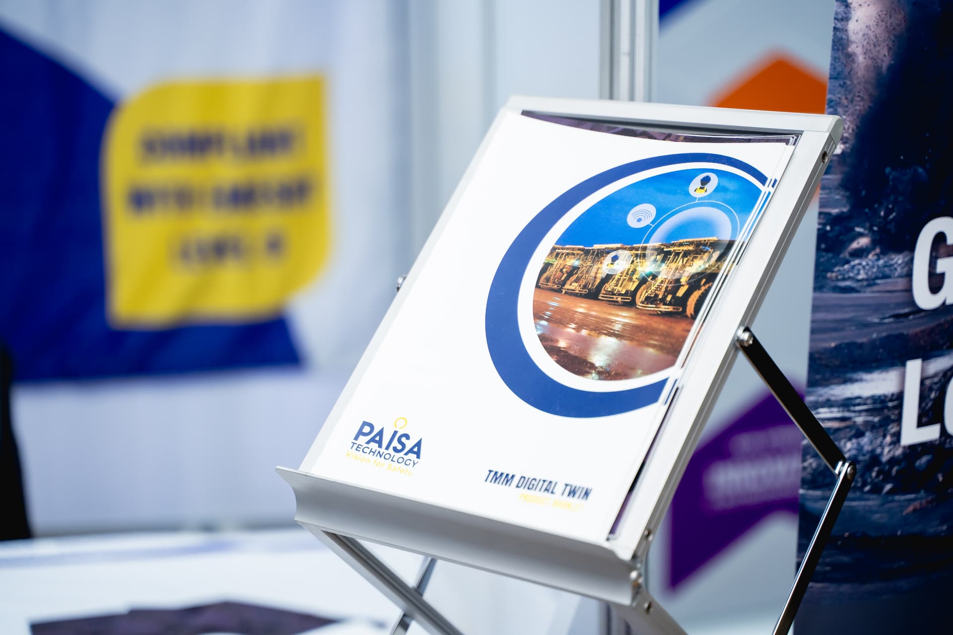 Exhibitor product brochure displayed on a stand at the conference