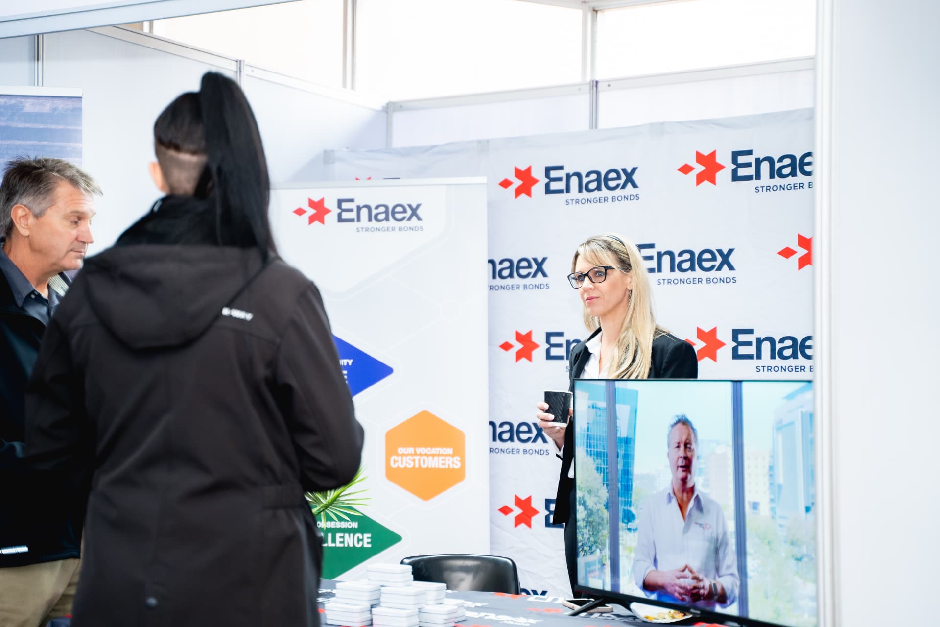 Exhibitor team in conversation with delegates at a fully branded stand