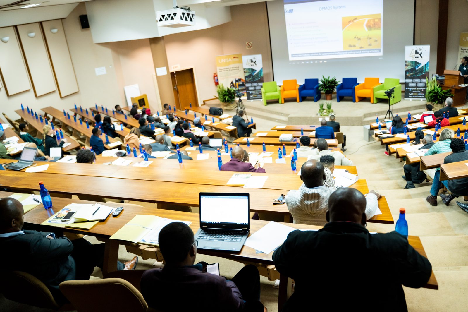 A full lecture theatre of delegates during a session